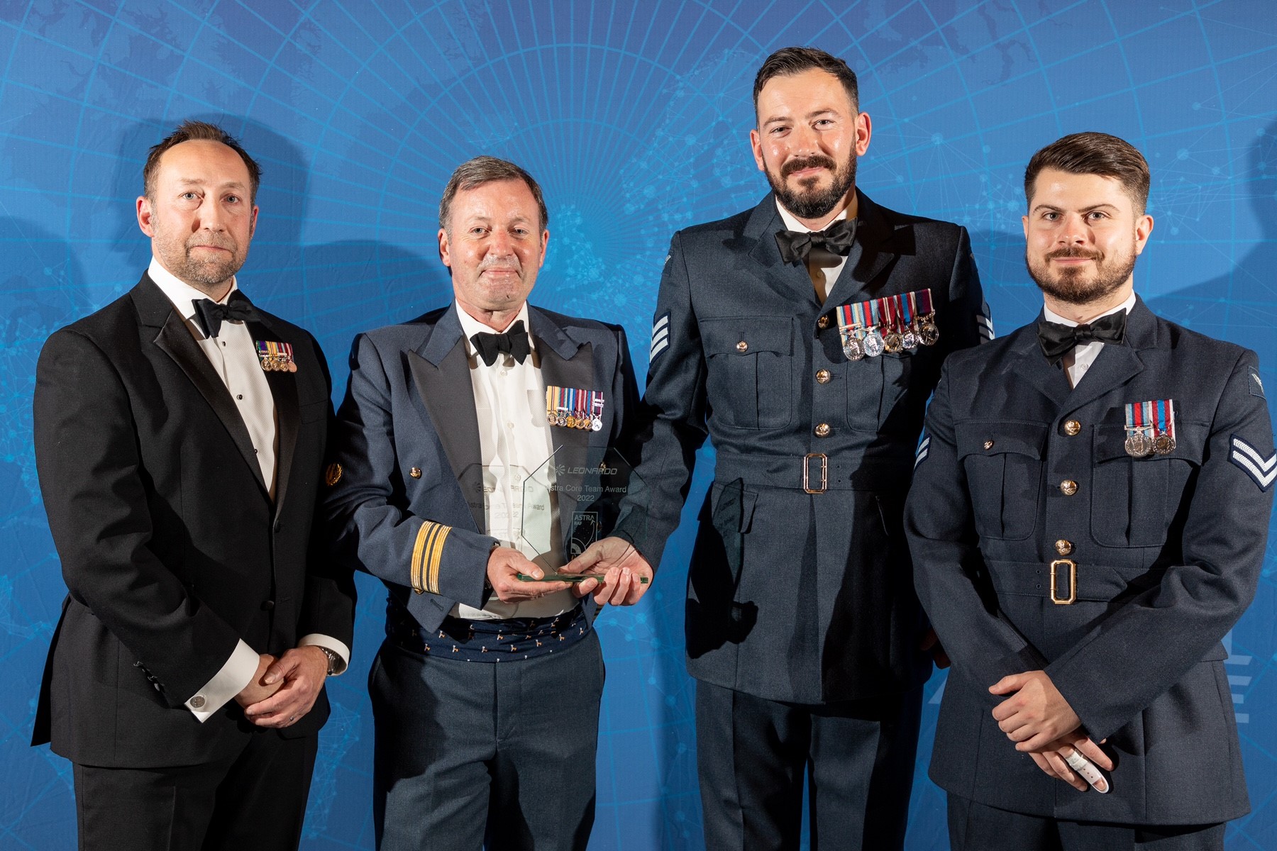 Image shows RAF aviator holding award for picture.